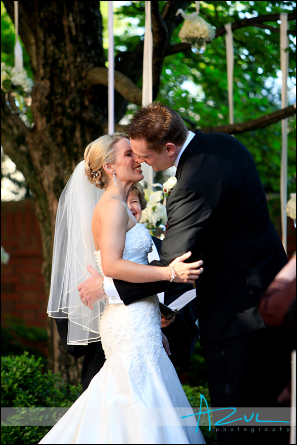 The groom kisses his bride during the wedding ceremony at the Carolina Inn..