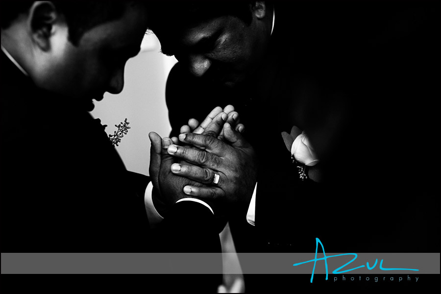 Hands cross in prayer before the wedding ceremony