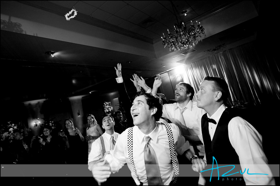 Action photography of the toss during a Raleigh wedding reception