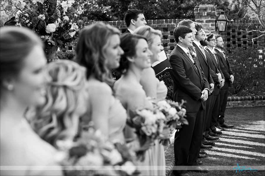 Groom, groomsmen and bridesmaids line up during the ceremony Raleigh NC