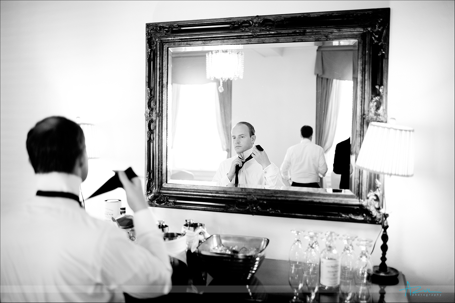 Photography of groom in mirror prior to wedding ceremony at The Carolina Inn NC