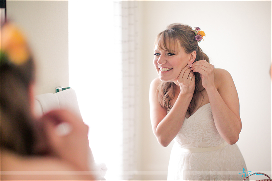 Beautiful bride getting ready in perfect light for wedding photographer