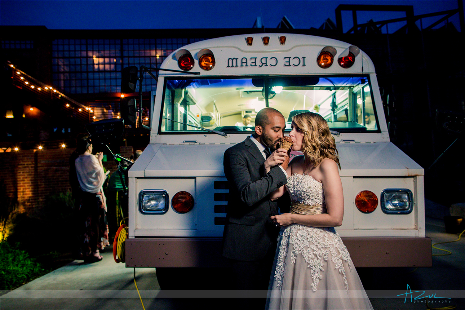 Photographer captures the wedding day couple sharing a toast with ice cream after the ceremony in Raleigh NC