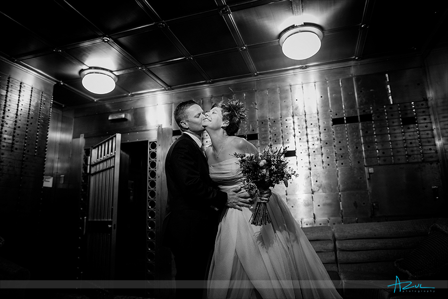 21C wedding day portrait of the bride and groom inside the bank vault located in Durham, NC