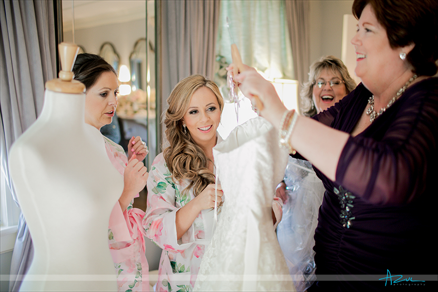 On the wedding day the bride and her mom has a candid photograph taken of them together, at Highgrove Estate in NC