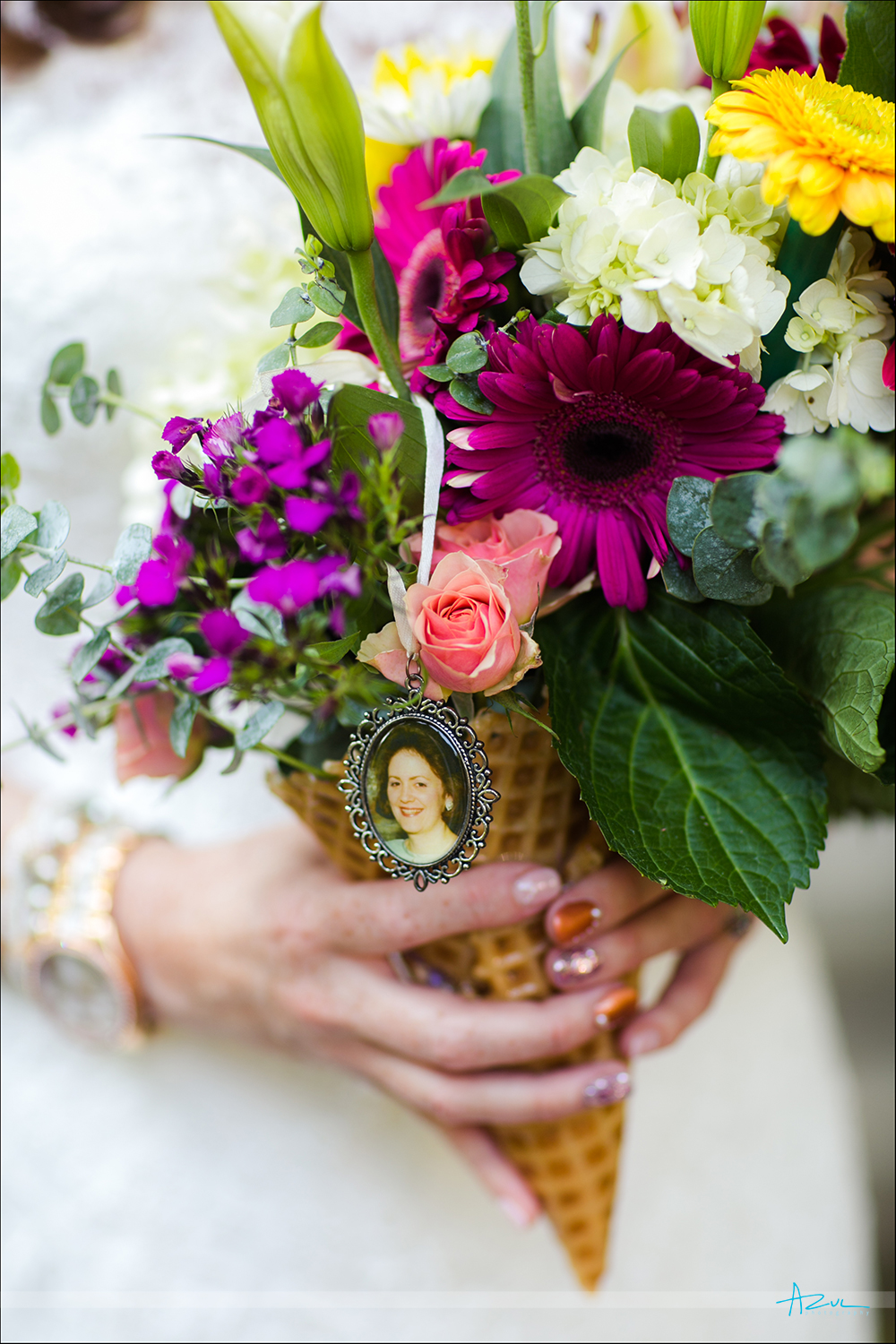 A bouguet with a photograph of mom keeps her memory alive during a wedding in Raleigh NC