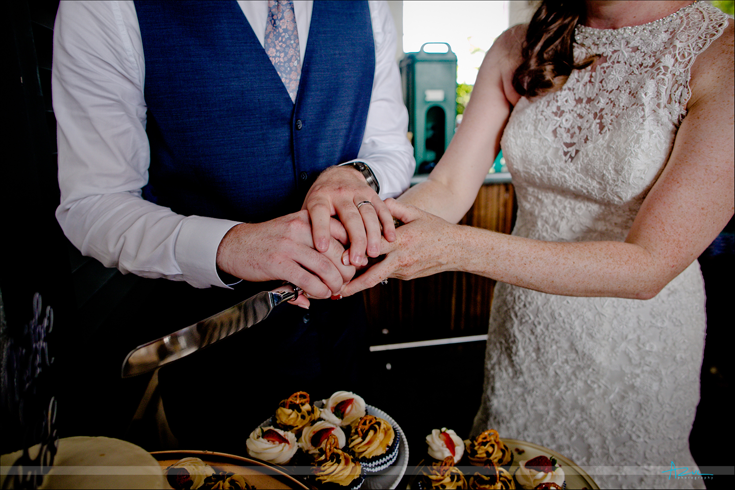 Wonderful detail shot of hands cutting the cake with the B&G at the reception in Raleigh.